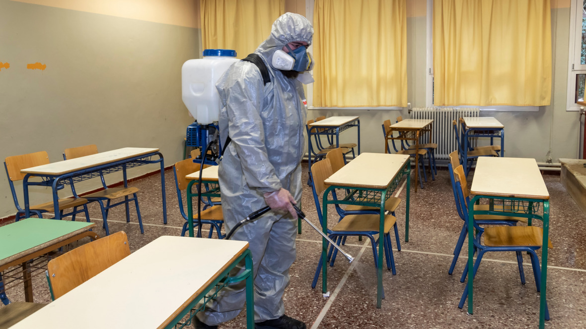 A man disinfecting a classroom in Thessaloniki to halt the spread of the coronavirus.