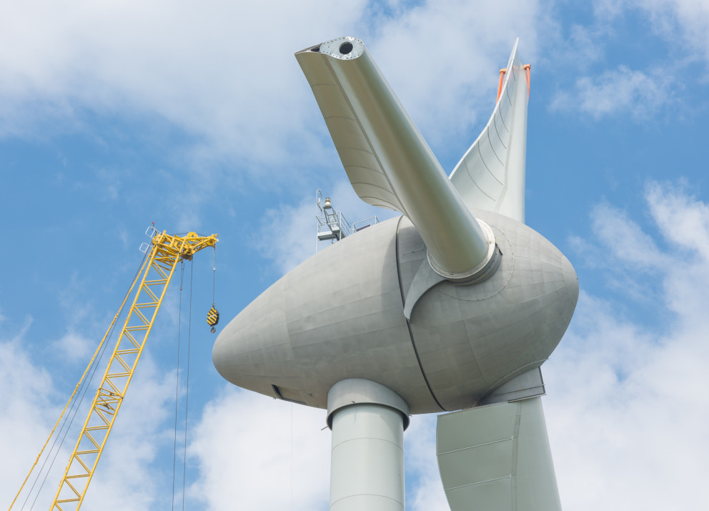 Assembly of blades on a wind turbine: Many countries require renewable energy projects to use a certain share of locally-made components.
